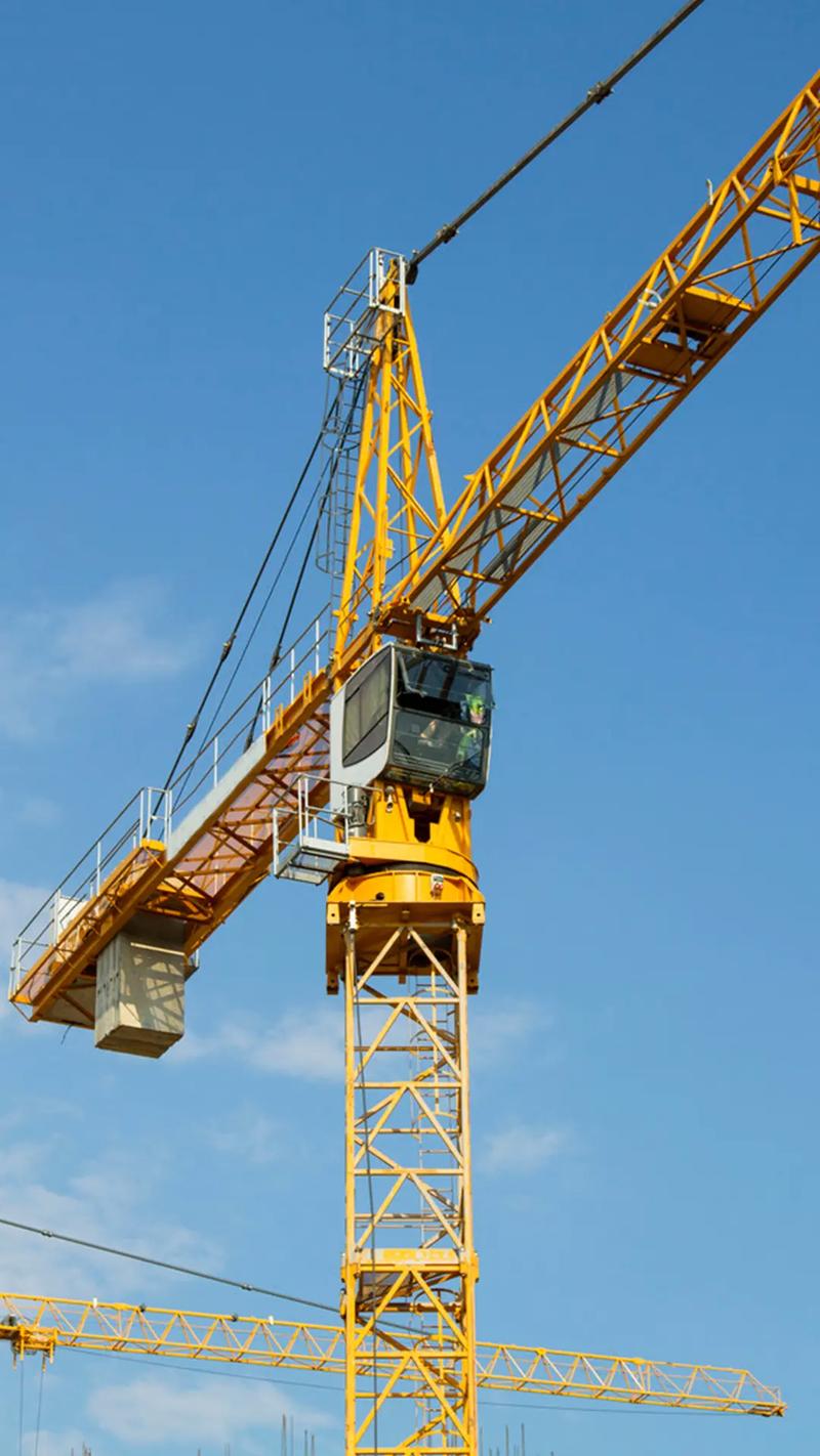 Construction site with crane and heavy equipment machinery for global infrastructure project